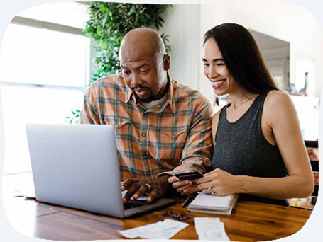 Smiling frustrated woman in front of laptop